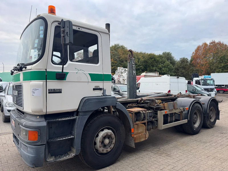 MAN 33.403 **BELGIAN TRUCK-FULL STEEL-MANUAL PUMP** - Hook lift truck: picture 1 MAN 33.403 **BELGIAN TRUCK-FULL STEEL-MANUAL PUMP** - Hook lift truck: picture 1